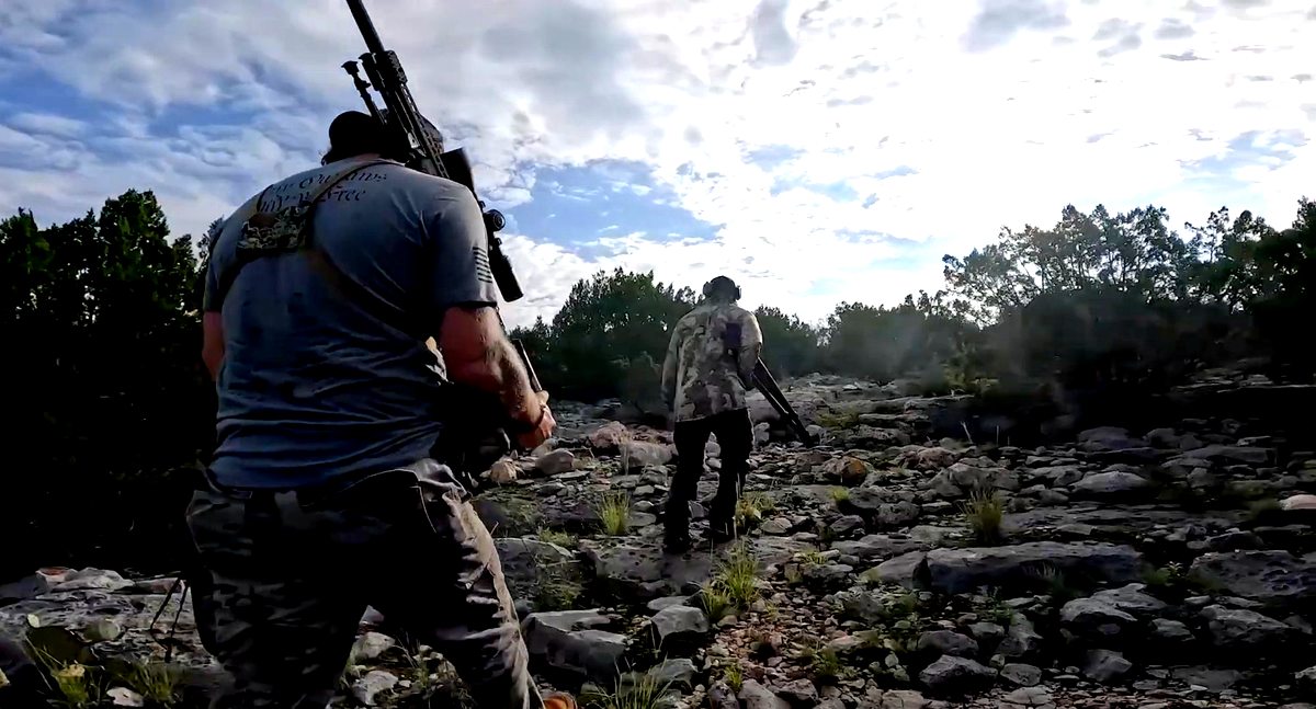 Two hunters on Čhetáŋ Pahá ridge at dusk — Rage Six Ranch